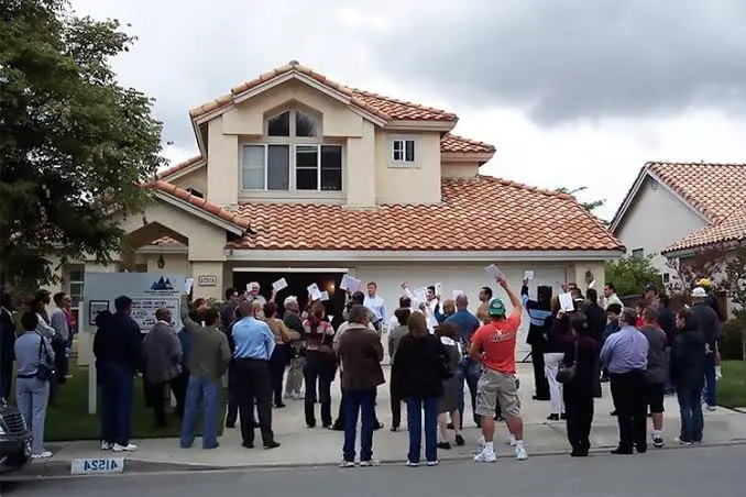 Bidders assembled outside a residential property for a public auction